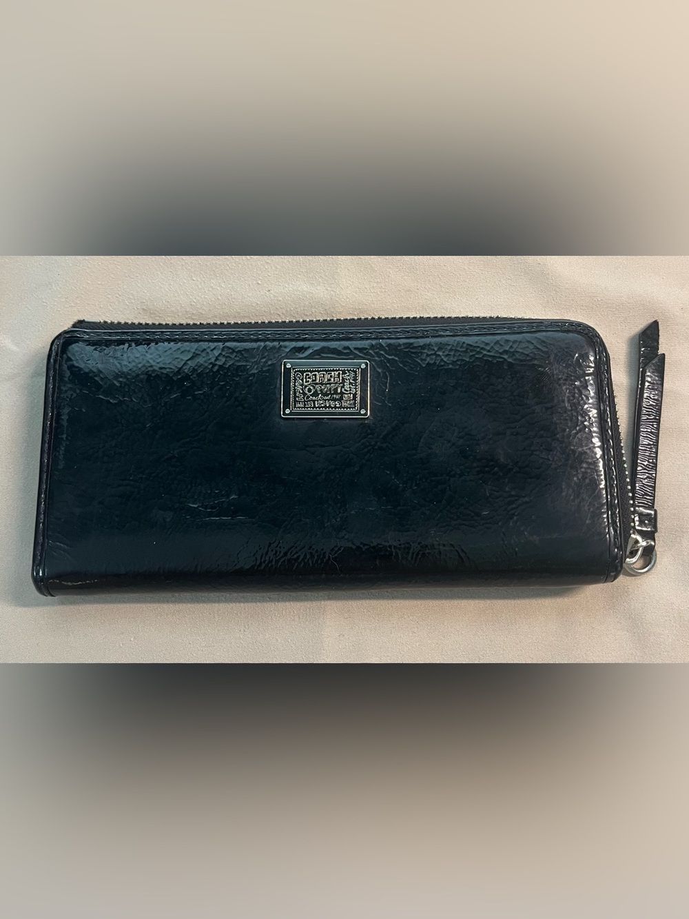 Coach Poppy Black Patent Zip-Around Wallet with Logo Plate.